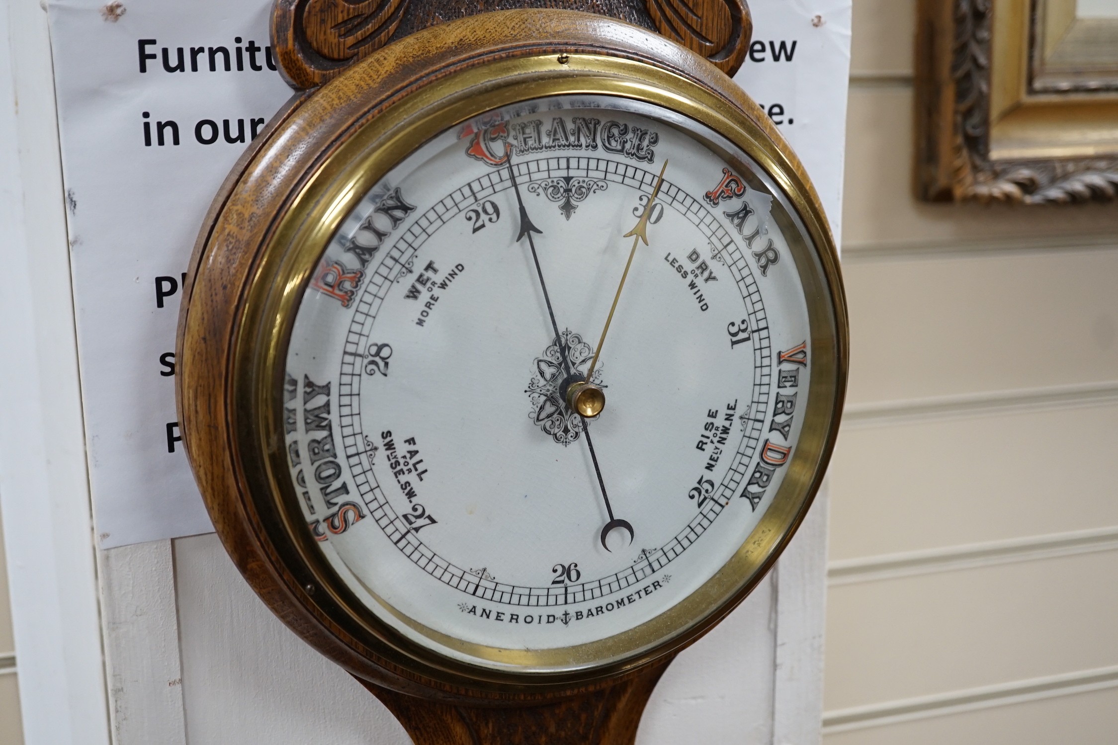 An Edwardian carved oak aneroid wheel barometer, 85cm *Please note the sale commences at 9am.